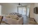 Living room featuring a sectional sofa, large mirror, and tile flooring at 913 S 115Th Dr, Avondale, AZ 85323