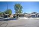 Three similar homes with attached garages and mature trees at 913 S 115Th Dr, Avondale, AZ 85323