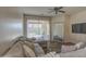 Living room with sectional sofa, large mirror, and access to backyard at 913 S 115Th Dr, Avondale, AZ 85323