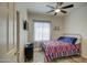 Bedroom with striped bedding, tiled floor, and a closet at 913 S 115Th Dr, Avondale, AZ 85323