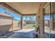 Covered patio and grassy backyard with block wall at 913 S 115Th Dr, Avondale, AZ 85323