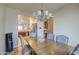 Bright dining room with a wooden table and chandelier at 913 S 115Th Dr, Avondale, AZ 85323