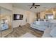 Living room with sectional sofa, large mirror, and view of kitchen at 913 S 115Th Dr, Avondale, AZ 85323