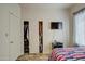 Bedroom with sliding door closet and additional storage at 913 S 115Th Dr, Avondale, AZ 85323