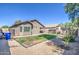 House backyard with grassy area and block wall at 913 S 115Th Dr, Avondale, AZ 85323