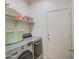 Laundry room with washer, dryer, and shelving at 913 S 115Th Dr, Avondale, AZ 85323