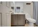 Bathroom with toilet, sink, and shower. Gray vanity at 913 S 115Th Dr, Avondale, AZ 85323