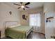 Bright bedroom with a metal bed frame and window coverings at 913 S 115Th Dr, Avondale, AZ 85323
