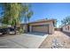 Single-story home with a two-car garage and desert landscaping at 913 S 115Th Dr, Avondale, AZ 85323