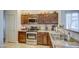 Kitchen with dark wood cabinets, stainless steel appliances, and granite countertops at 913 S 115Th Dr, Avondale, AZ 85323