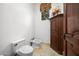 Small powder room with pedestal sink and wooden cabinet at 9705 E Cholla St, Scottsdale, AZ 85260