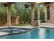 Relaxing spa with a waterfall feature and pergola at 9705 E Cholla St, Scottsdale, AZ 85260