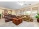 Comfortable living room with leather sofas and a coffee table at 26723 N 127Th Dr, Peoria, AZ 85383