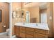 Elegant bathroom with double sinks and a large mirror at 26723 N 127Th Dr, Peoria, AZ 85383