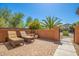 Relaxing patio with lounge chairs, brick pavers, and desert landscaping at 26723 N 127Th Dr, Peoria, AZ 85383