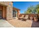 Small patio with lounge chairs and a view of the house at 26723 N 127Th Dr, Peoria, AZ 85383