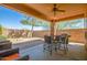 Relaxing patio with seating area and built-in grill at 26723 N 127Th Dr, Peoria, AZ 85383