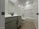 Bathroom with gray vanity, tub, and tile floor at 5663 S 240Th Ln, Buckeye, AZ 85326