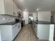 Modern kitchen with gray cabinets, quartz countertops, and stainless steel appliances at 5663 S 240Th Ln, Buckeye, AZ 85326