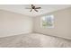 Bedroom with ceiling fan and large window at 13036 N 20Th St, Phoenix, AZ 85022