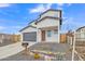 Modern two-story home with gray garage door and wood fence at 13036 N 20Th St, Phoenix, AZ 85022