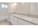 Bathroom with double vanity, granite countertop, and bathtub at 13036 N 20Th St, Phoenix, AZ 85022