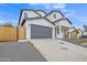 Modern two-story home with gray garage door and wood fence at 13036 N 20Th St, Phoenix, AZ 85022