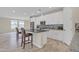 Modern kitchen featuring white cabinets, granite countertops, and breakfast bar at 13036 N 20Th St, Phoenix, AZ 85022