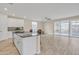 Open kitchen with large island, granite countertops and sliding doors to backyard at 13036 N 20Th St, Phoenix, AZ 85022