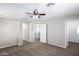 Bedroom with ceiling fan, carpet, and access to hallway at 824 E Agua Fria Ln, Avondale, AZ 85323