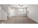 Bright and airy living room with carpeted floors and a staircase at 824 E Agua Fria Ln, Avondale, AZ 85323