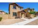 Two-story stucco home with a terracotta tile roof, shutters, and a welcoming front porch at 824 E Agua Fria Ln, Avondale, AZ 85323
