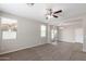 Spacious living room with carpet, and sliding glass door to patio at 824 E Agua Fria Ln, Avondale, AZ 85323