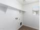 Laundry room with overhead shelving and window at 824 E Agua Fria Ln, Avondale, AZ 85323
