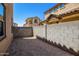 Small gravel backyard with block wall and neighboring homes at 824 E Agua Fria Ln, Avondale, AZ 85323
