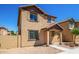 Two-story stucco home with a terracotta tile roof, shutters, and a welcoming front porch at 824 E Agua Fria Ln, Avondale, AZ 85323