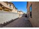 Small gravel backyard with block wall and neighboring homes at 824 E Agua Fria Ln, Avondale, AZ 85323