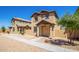 Two-story stucco home with a terracotta tile roof, shutters, and a welcoming front porch at 824 E Agua Fria Ln, Avondale, AZ 85323