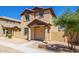 Two-story stucco home with a terracotta tile roof, shutters, and a welcoming front porch at 824 E Agua Fria Ln, Avondale, AZ 85323
