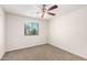 Bright bedroom with ceiling fan and window at 847 E Agua Fria Ln, Avondale, AZ 85323