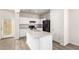 Modern kitchen with white cabinets, granite counters, and island at 847 E Agua Fria Ln, Avondale, AZ 85323