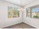 Dining area with wood-look flooring and window blinds at 847 E Agua Fria Ln, Avondale, AZ 85323