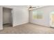 Bright bedroom with neutral-colored carpet and ceiling fan at 847 E Agua Fria Ln, Avondale, AZ 85323