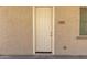 White front door entrance to the home with address number 847 at 847 E Agua Fria Ln, Avondale, AZ 85323