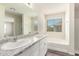 Bathroom with double vanity, bathtub, and window at 847 E Agua Fria Ln, Avondale, AZ 85323