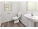 Clean bathroom with pedestal sink and toilet at 847 E Agua Fria Ln, Avondale, AZ 85323