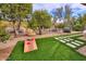 Landscaped backyard with a walkway and cornhole at 7581 E Pasaro Dr, Scottsdale, AZ 85266