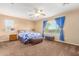 Main bedroom with carpeted floor, ceiling fan and window treatments at 17797 W Carmen Dr, Surprise, AZ 85388