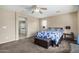 Main bedroom with ceiling fan, carpet, and ensuite bathroom at 17797 W Carmen Dr, Surprise, AZ 85388