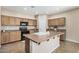 Modern kitchen with island, lots of storage and breakfast bar at 17797 W Carmen Dr, Surprise, AZ 85388